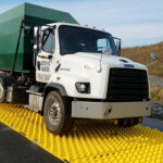 Large delivery truck driving on FODs ground protection mud mat.