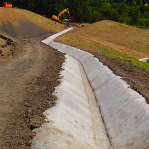 Concrete canvas along a channel or culvert for erosion protection