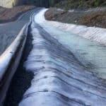 Concrete canvas along a channel for erosion protection