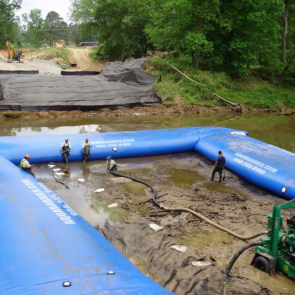 AquaBarrier lining a large body of water in order to help prevent flooding