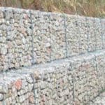 Stacked cage gabion filled with rock for construction foundation