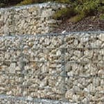 Wall stabilization using gabion cages filled with rock