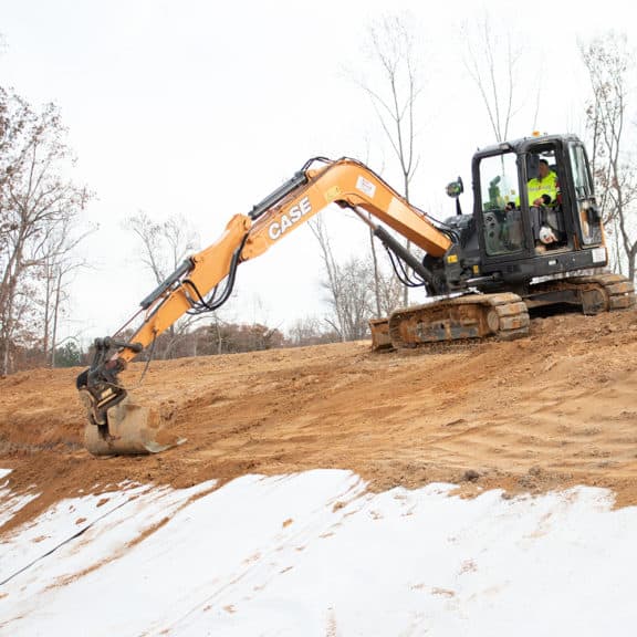 Professionals installing an innovative impermeable geosynthetic clay liner