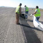 Stormwater professionals installing Petrotac Self-Adhesive Paving Membrane