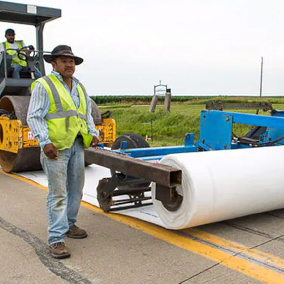 Installing Reflectex concrete pavement interlayer system to reduce road surface temperature