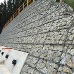 Wire mesh cage retaining wall new outflow pipe