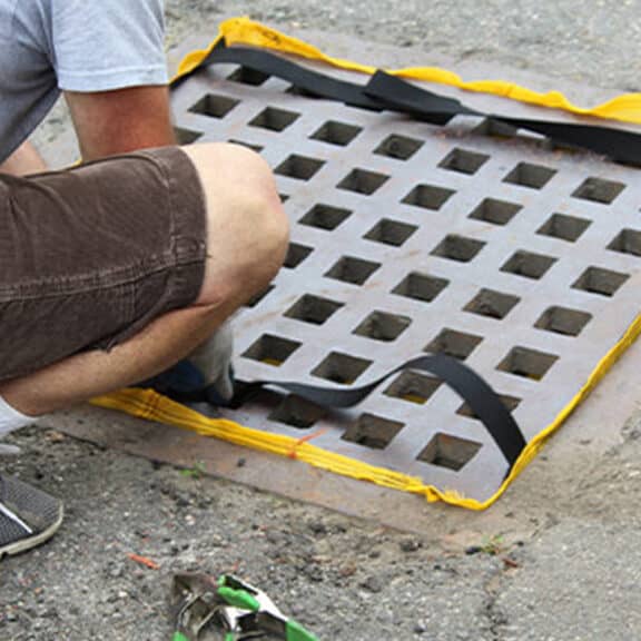 A professional checking the EconoSack after heavy rainfall to prevent ponding