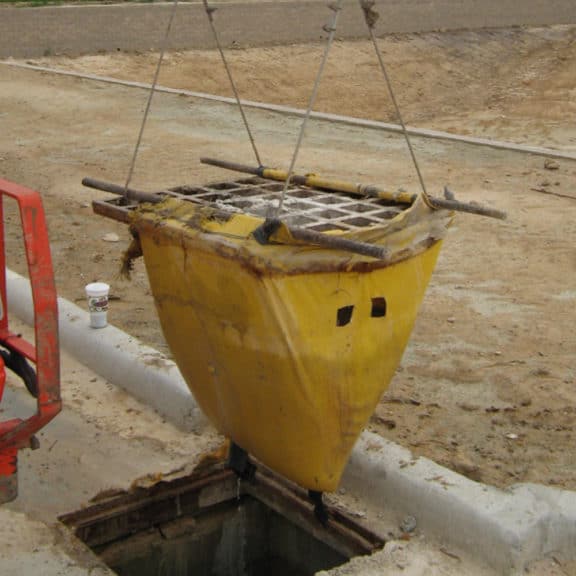 SiltSack being lowered into a catch basin