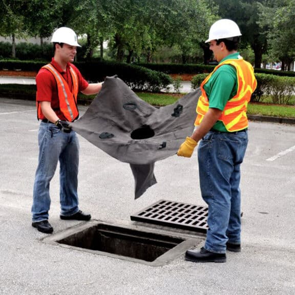 Construction workers dropping a SiltSack NW into place.