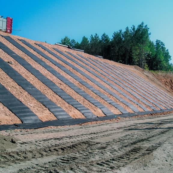 Installing high-quality stormwater drainage system using retaining wall sheet and strip drains