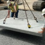 A precast stormcrete slab being placed in a parking lot.