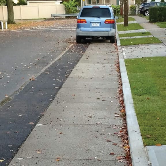 STORMCRETE porous concrete slabs in a road gutter to better control stormwater runoff.