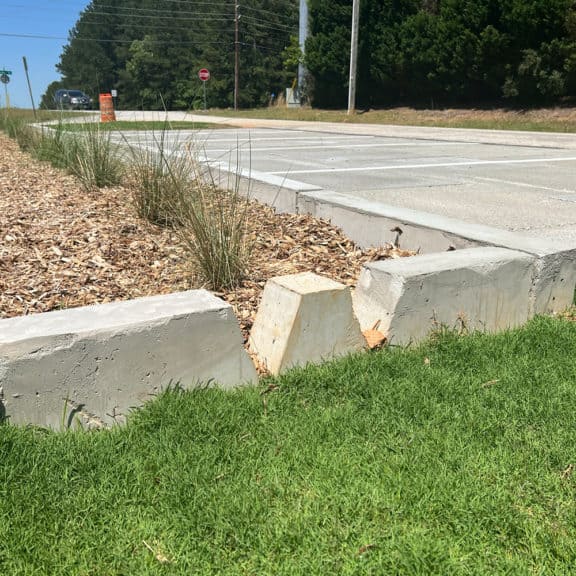 A large curb with strategically cut slits to direct stormwater