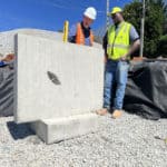 Two stormwater experts placing precast twalls