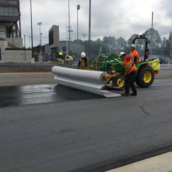 Installing Tencate Mirafi MPG paving geocomposite on asphalt