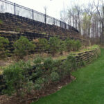 Tiered retaining wall with vegetation.