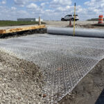 Professional installation of Tensar InterAx Geogrid for road stabilization