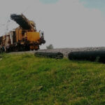 Installing uniaxial geogrids along train track embankment