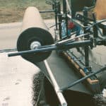 Installation of high-strength paving fabrics for asphalt