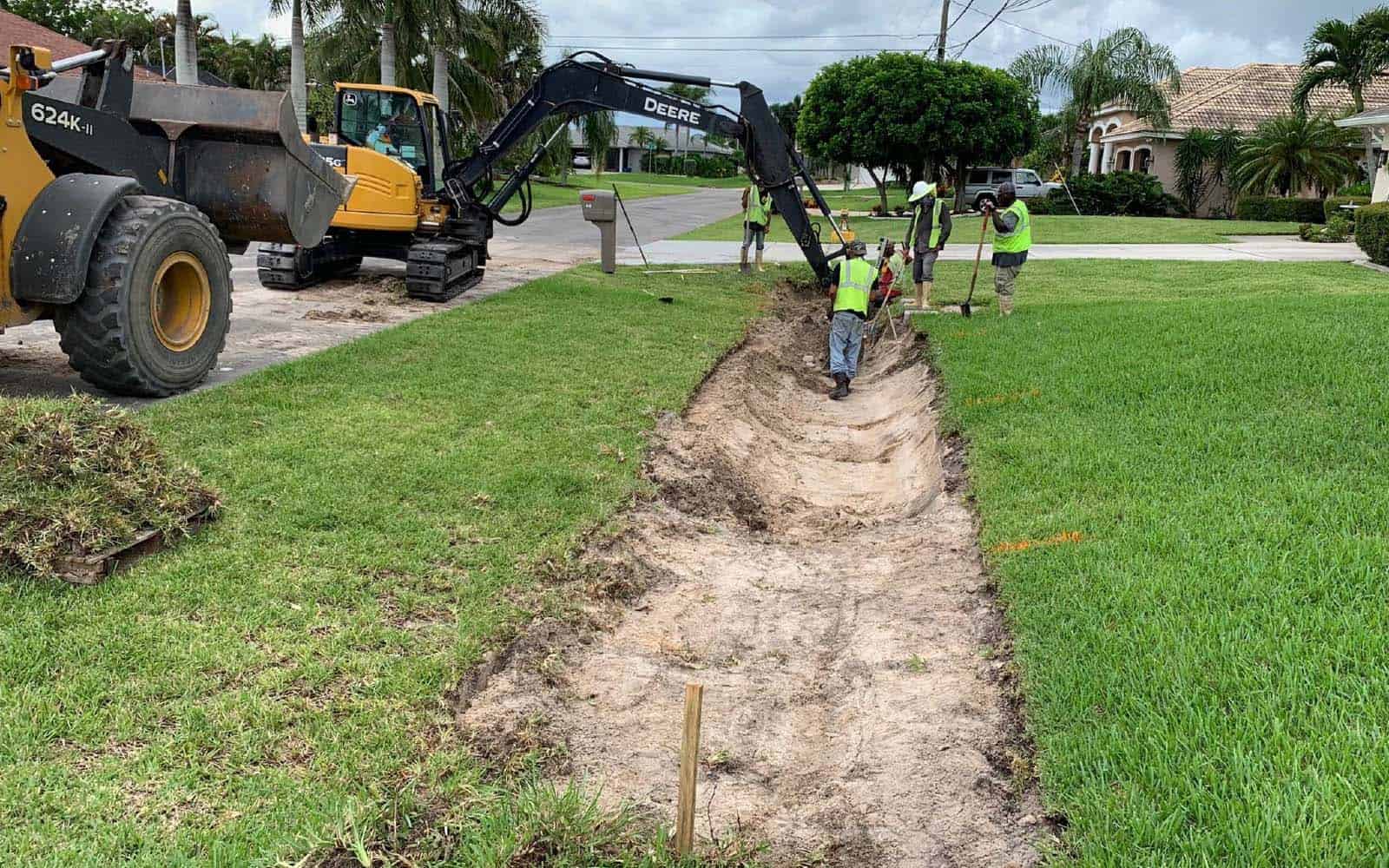 Digging a trench during the Cape Coral North 2 utilities expansion project to install bold and gold filtration media.