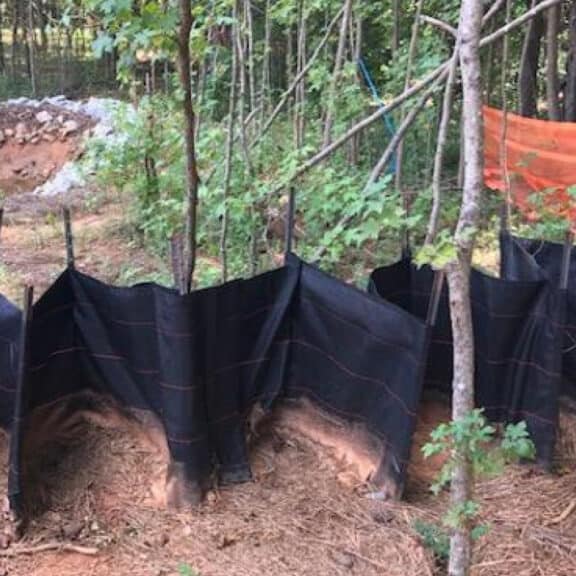 Installation of corrugated retention and filtration system in a wooded area