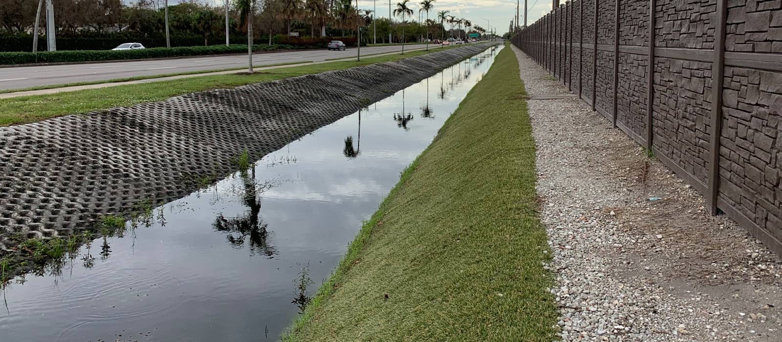 Hard armor system, hydro turf, lining the ditch of a busy street in Naples Florida and preventing both flooding and erosion.