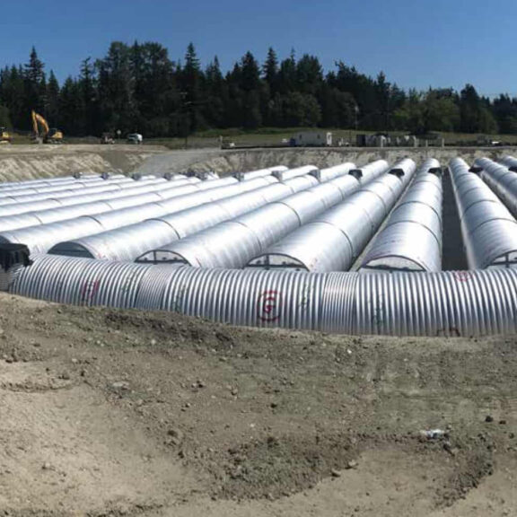 Installation of corrugated metal drainage pipe for stormwater management