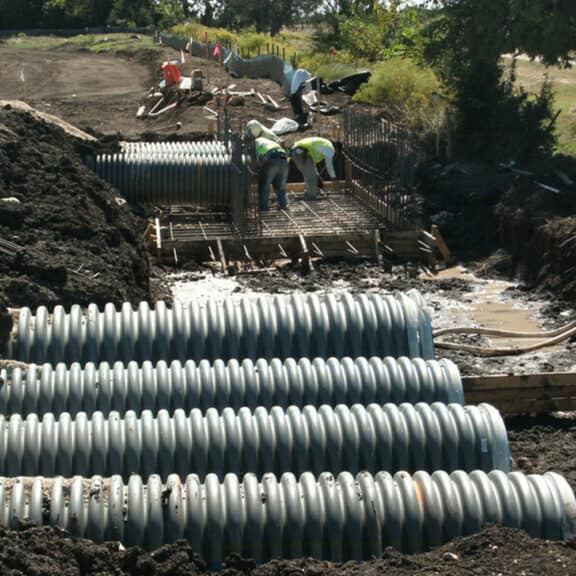 N-12 and HP corrugated storm pipe ready for installation on a job site