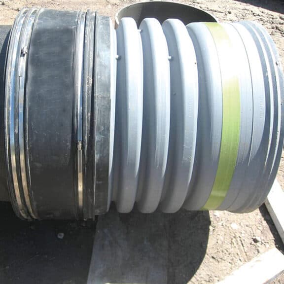 A joint within a corrugated HDPE pipe drainage system