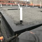 Installation of stormwater chamber in shallow area beneath a parking lot