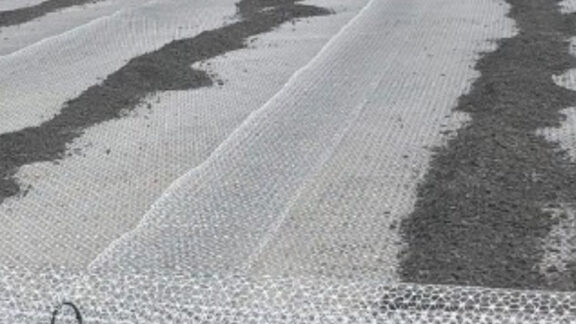 A high-strength geotextile being installed at a container yard for superior ground stabilization.