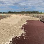 Adding ground stabilization Mirafi geotextiles on miles of roadway