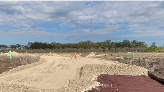 Adding ground stabilization Mirafi geotextiles on miles of roadway