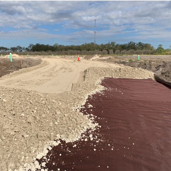 Adding ground stabilization Mirafi geotextiles on miles of roadway