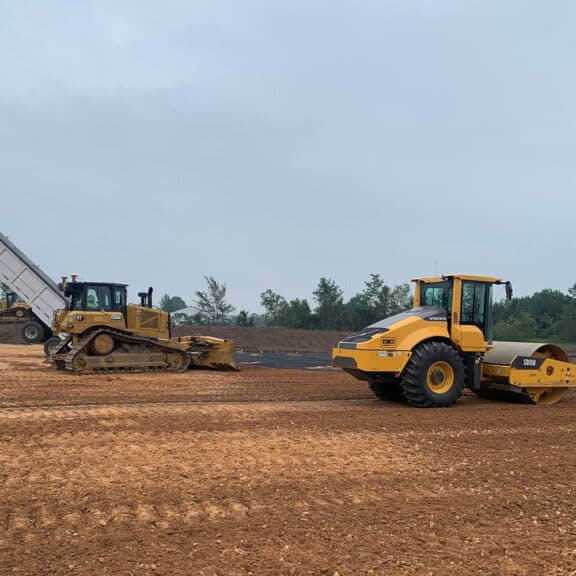 Installing geogrid geotextiles on highly trafficked site.