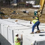 Geoengineers and stormwater professional installing an dnderground detention system