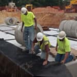 Geoengineers and construction professionals on a worksite preparing to install subsurface stormwater mangement solution, StormCapture