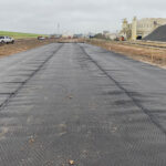 FilterGrid composite geogrid professional installed near industrial plant to solve for low-plasticity soil