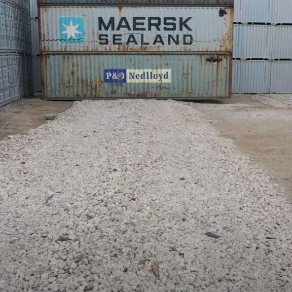 Tensar NX850 supporting gravel entrance in container yard that uses heavy machinery.