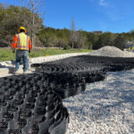 Construction professionals installing a geoweb system without heavy machinery.