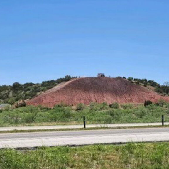 Exposed dirt on a steep slope that requires stabilization.