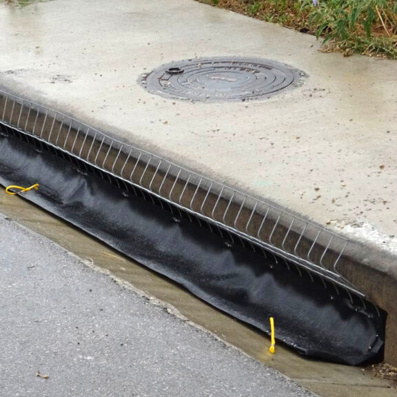 An installed GeoCurve inlet filter on a roadside curb