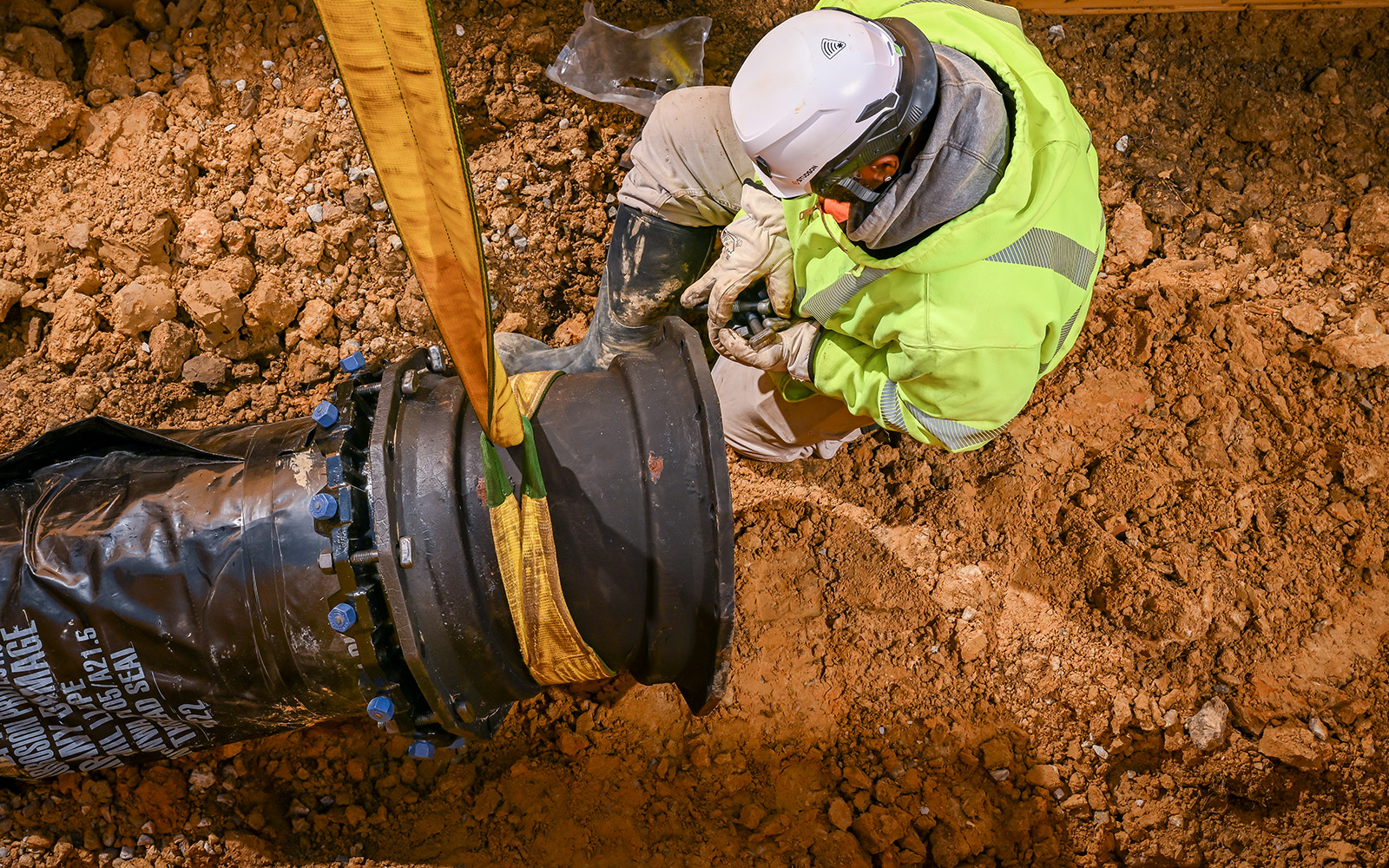 Underground utilities contractor installing pipe