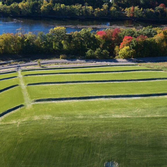 Grass covered hard armor solutions lining multiple water outflows.